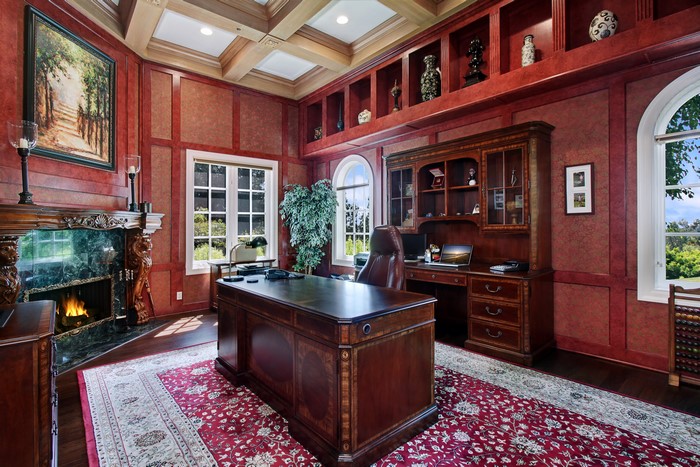 Luxurious home office with fireplace and large desk