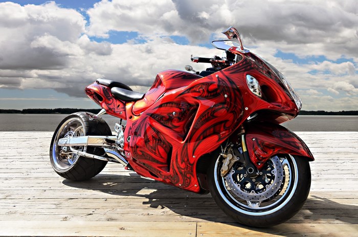 Red custom sportbike on a wooden pier