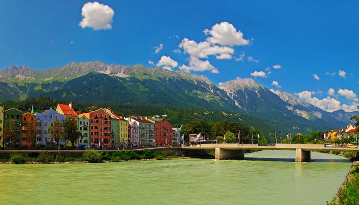Innsbruck Austria Riverfront with Mountains and Colorful Houses