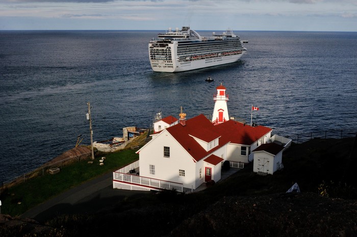 Cruise liner near a lighthouse on the coast of Newfoundland and Labrador