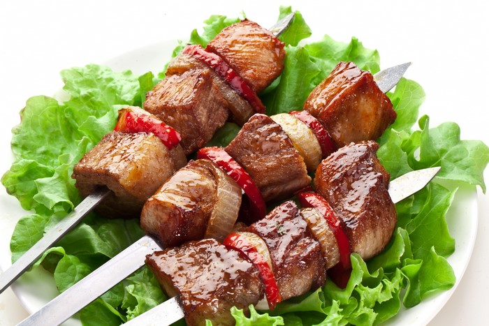 Meat shashlik on skewers with lettuce