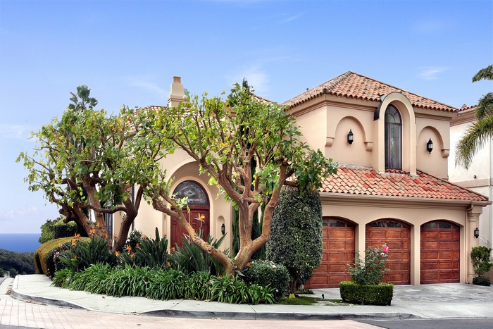 Mediterranean style house with trees and ocean view
