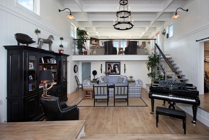 Living room with a grand piano and stairs
