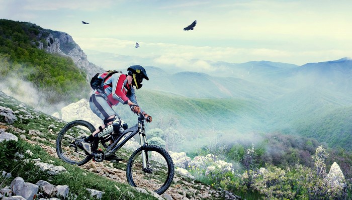 Mountain biker riding downhill on a rocky slope