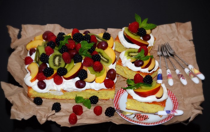 Fruit cake with whipped cream and berries