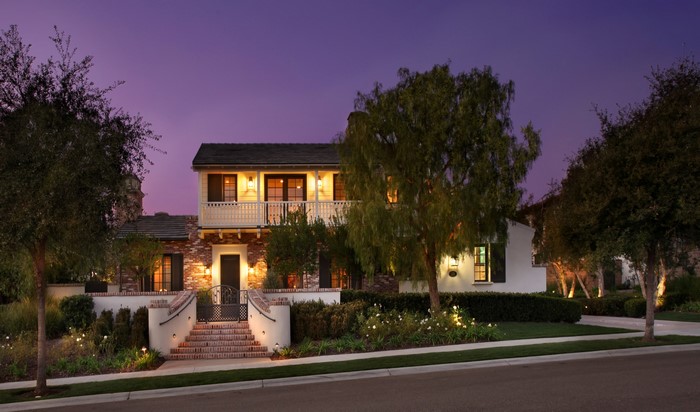 Luxury house with brick facade and balcony at dusk