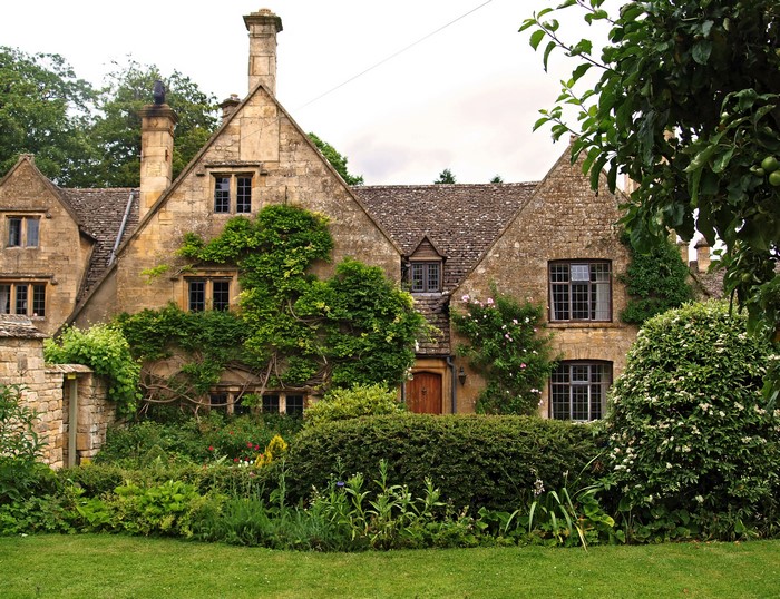 Stone house with ivy and garden in Tewkesbury, England