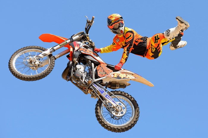 Motocross rider performing a trick in mid-air