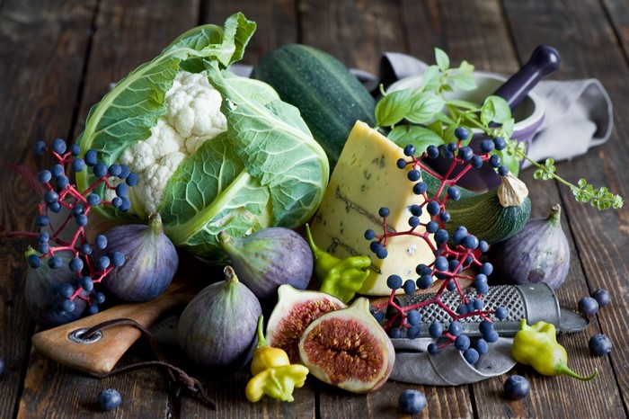 Still life with cauliflower, figs, cheese, and berries