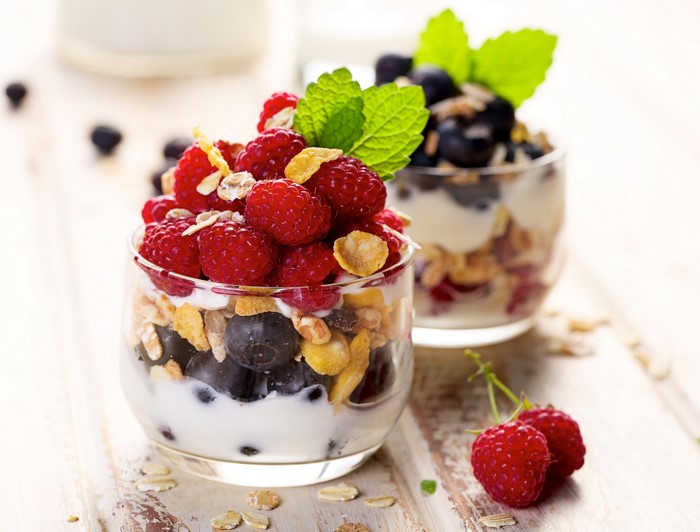Yogurt parfaits with raspberries, blueberries, and muesli in glasses