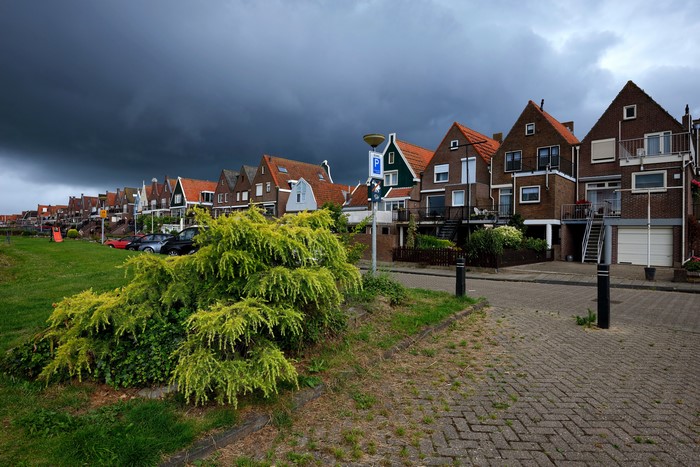 Row of houses in Volendam, Netherlands under stormy sky
