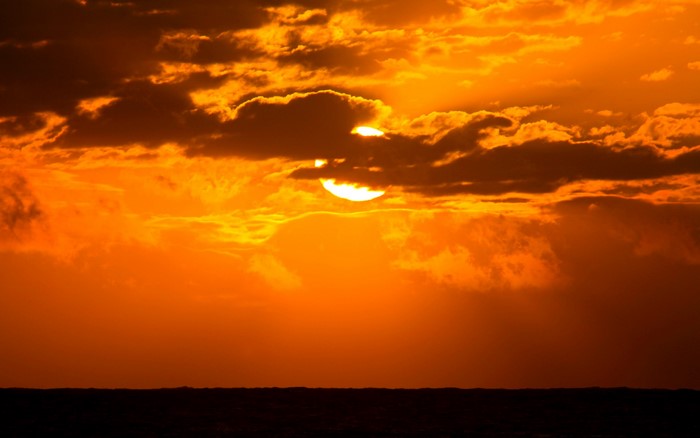 Sunset over the ocean with clouds