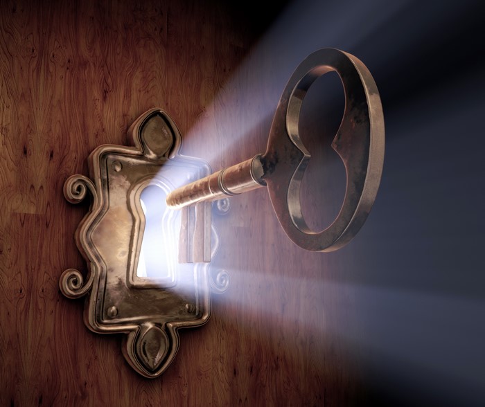 Keyhole with light rays and antique key
