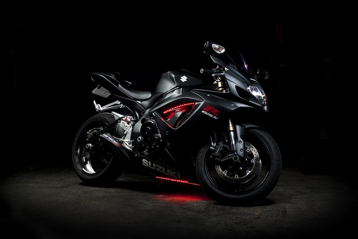 Black Suzuki GSX-R motorcycle with red LED lights