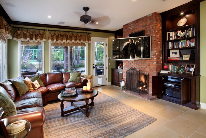 Living room with sectional sofa, fireplace, and TV