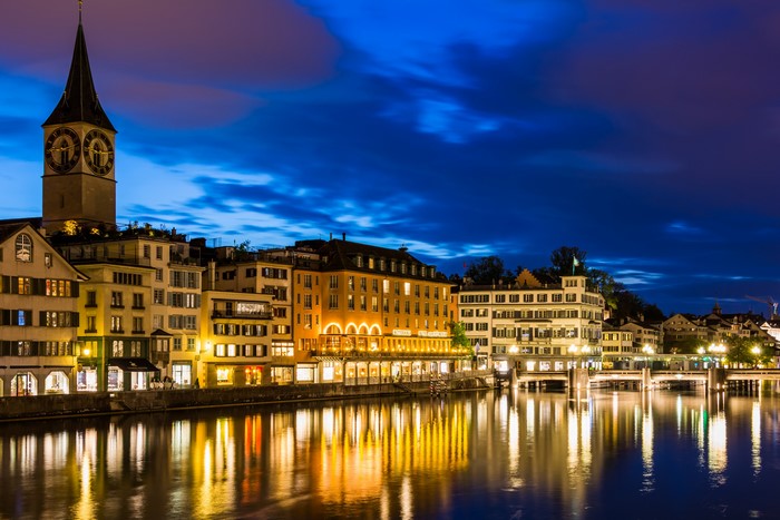 Zurich at night with clock tower and river