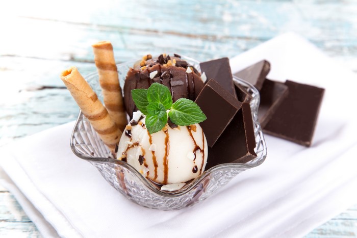 Chocolate and vanilla ice cream with chocolate bars and wafer rolls