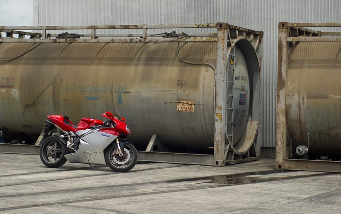 MV Agusta F4 Sportbike parked near industrial containers