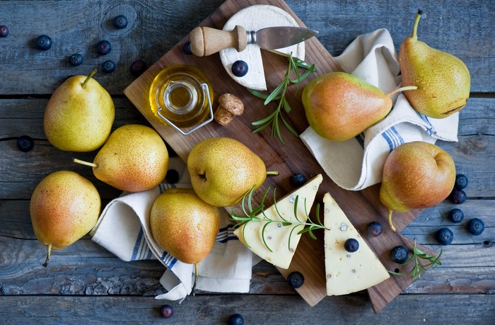 Pears, Cheese, Blueberries, and Olive Oil on a Wooden Board