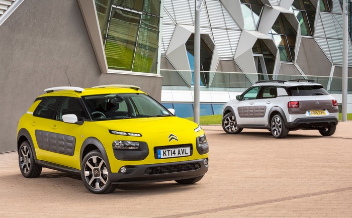 Two Citroen C4 Cactus cars parked outside a modern building