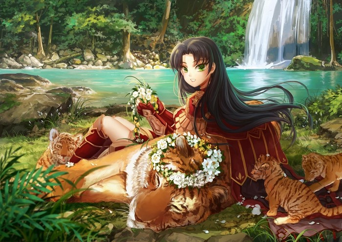 Brunette girl with tigers in a forest by a waterfall