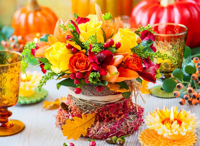 Autumn floral arrangement with pumpkins and candles