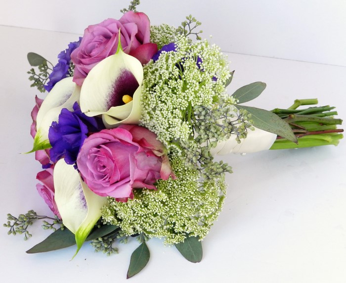 Bouquet of purple roses, white calla lilies, and eustoma