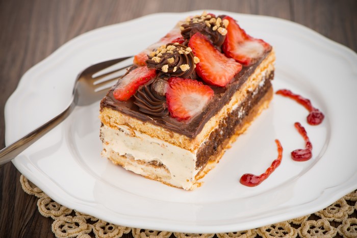 Strawberry chocolate cake slice on a plate with fork