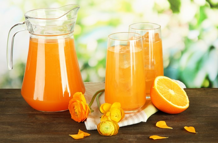 Orange Juice in Pitcher and Glasses with Orange Slice