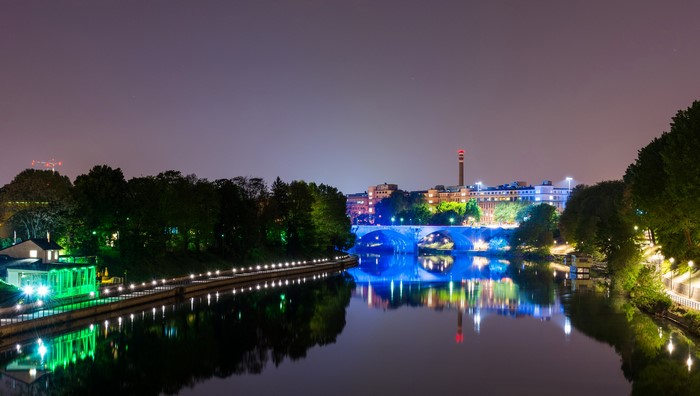 Turin river at night with illuminated bridge
