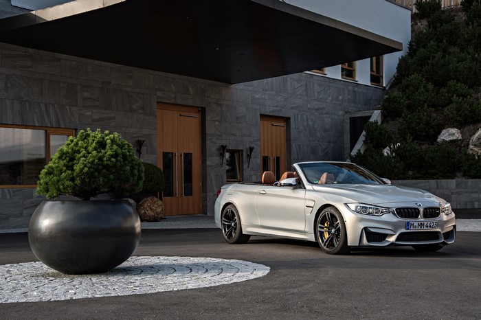 White BMW M4 Convertible parked outside a modern building