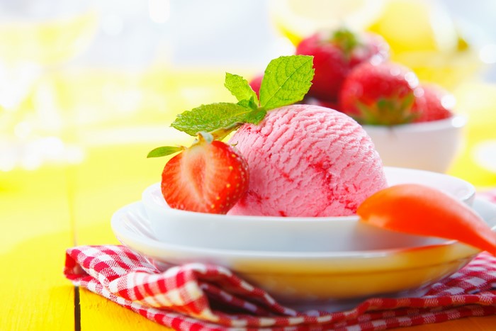 Strawberry ice cream with mint and strawberry on a plate