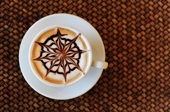Latte art coffee cup on saucer