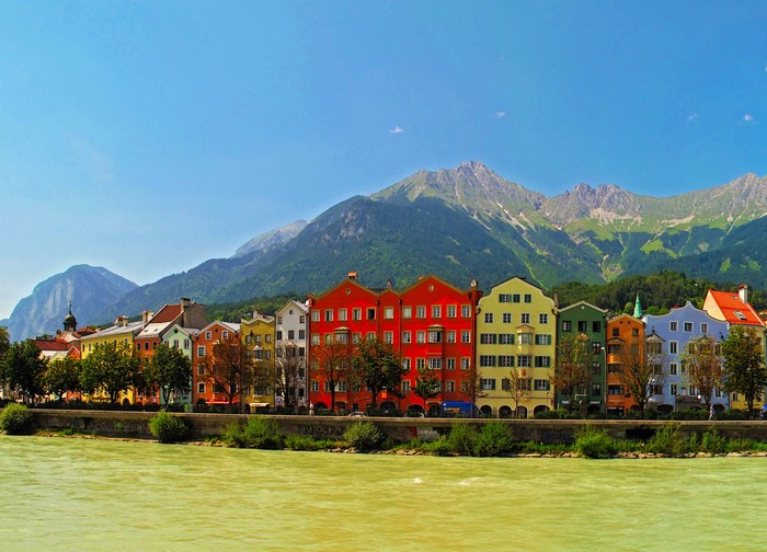 Colorful houses on the Inn River with mountains in Innsbruck, Austria