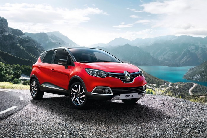 Red Renault Captur parked on a mountain road