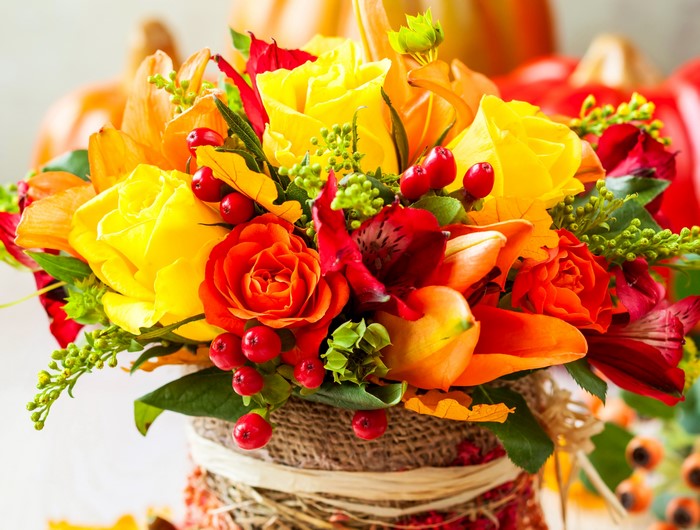 Autumn bouquet of roses and lilies with pumpkins
