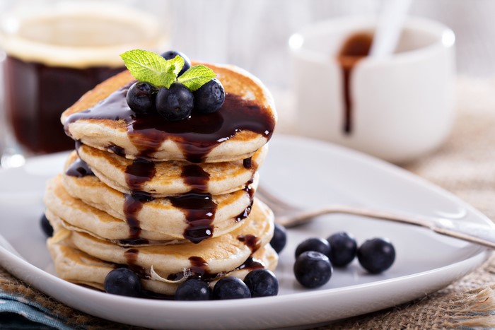 Pancakes with blueberries and chocolate syrup