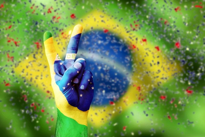 Hand painted with Brazil flag making peace sign