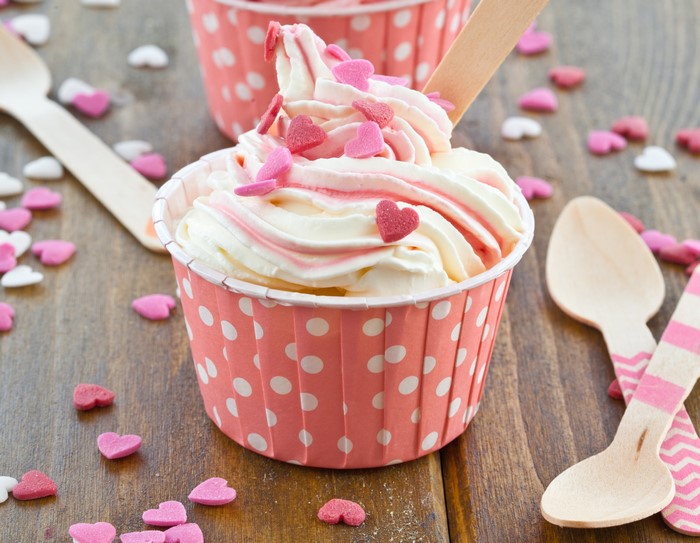 Ice cream with heart sprinkles and wooden spoons