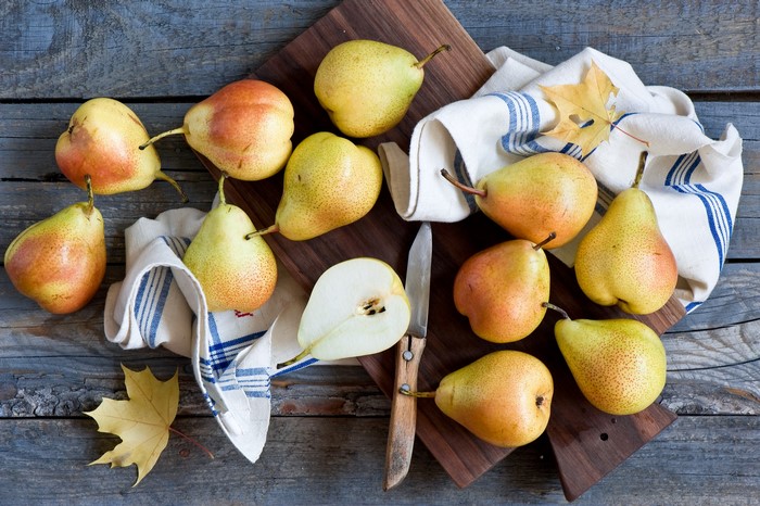 Pears and a knife on a wooden table