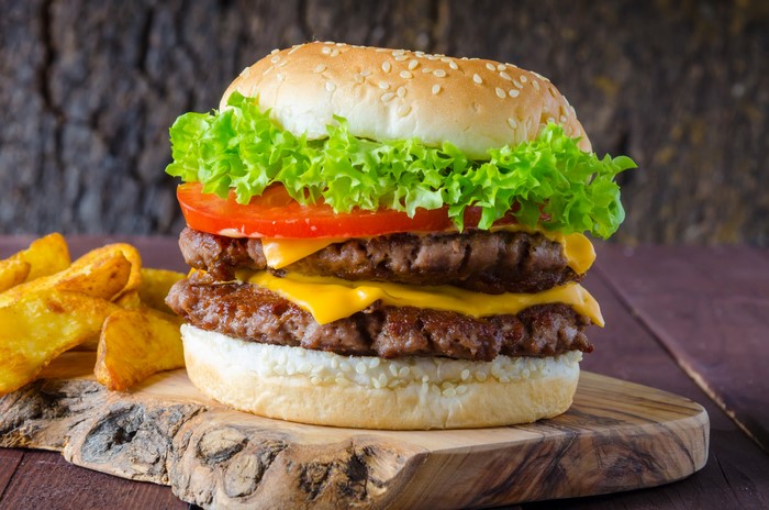 Double cheeseburger with lettuce, tomato, and fries