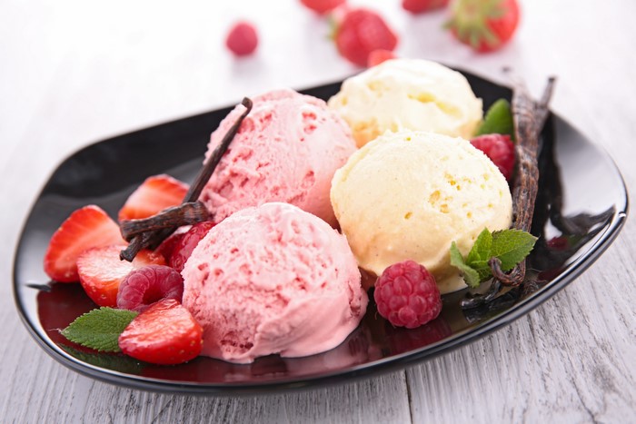 Ice cream with strawberries and raspberries on a plate