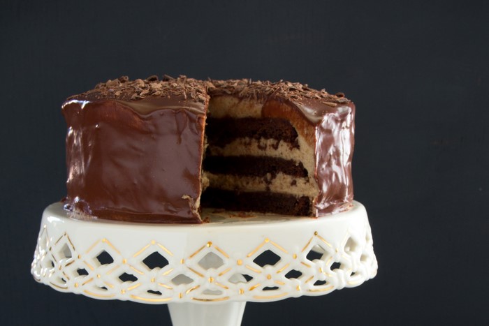 Chocolate cake with frosting on a cake stand