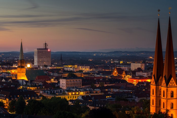 Cityscape at Dusk with Twin Spires and Modern Building