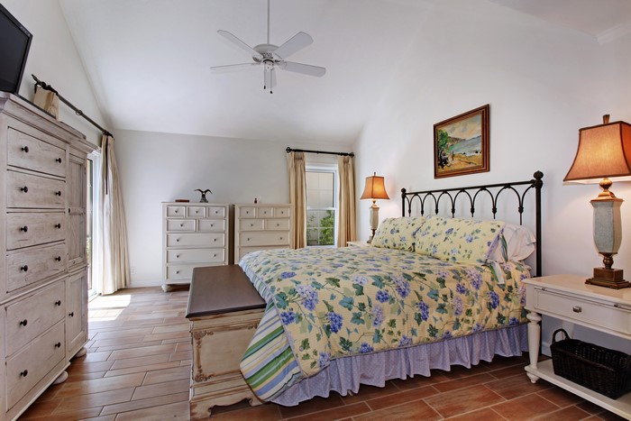 Bedroom with a bed, dressers, and lamps