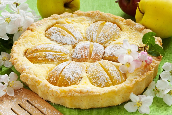 Apple pie with powdered sugar and apple blossoms