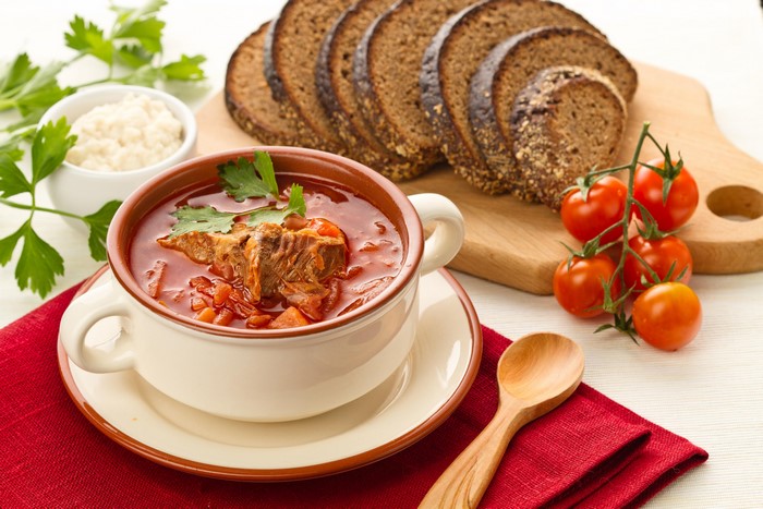 Borscht soup with bread and tomatoes