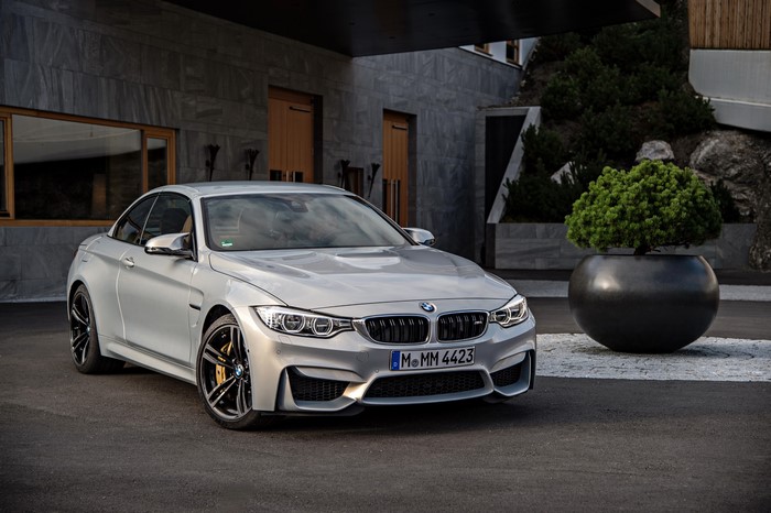 Silver BMW M4 Convertible parked outside modern building