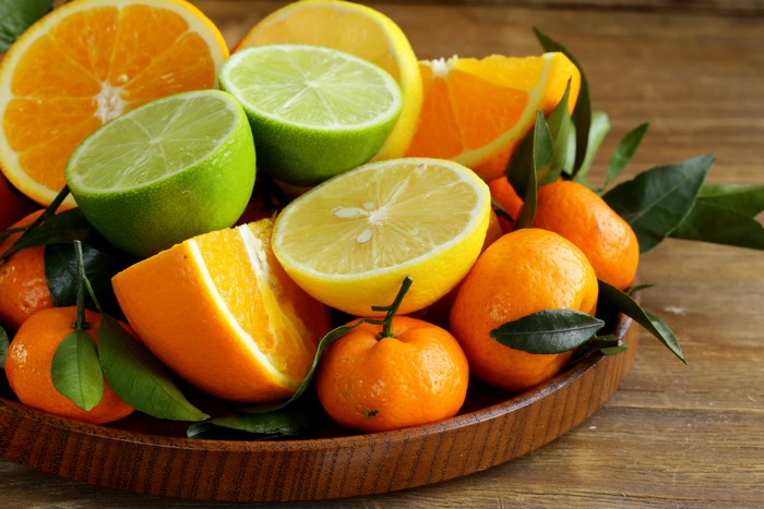 Assortment of Citrus Fruits in a Wooden Bowl
