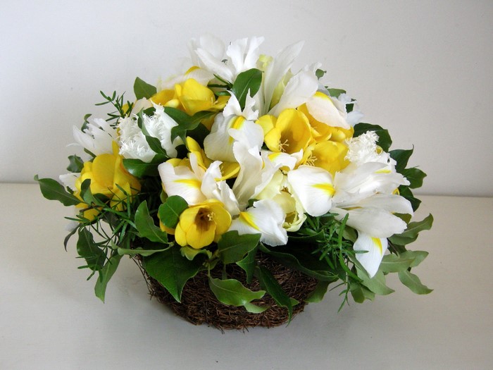 White and yellow flowers in a basket arrangement